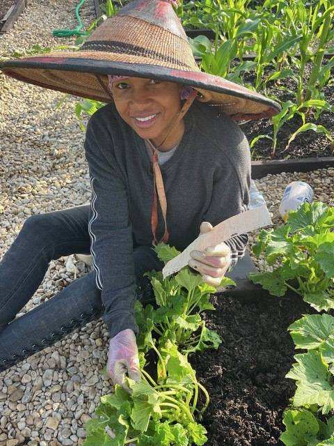 Gardener smiling among the crops
