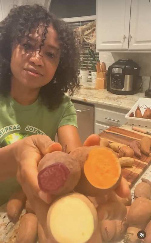 LaKisha showing sweet potato varieties